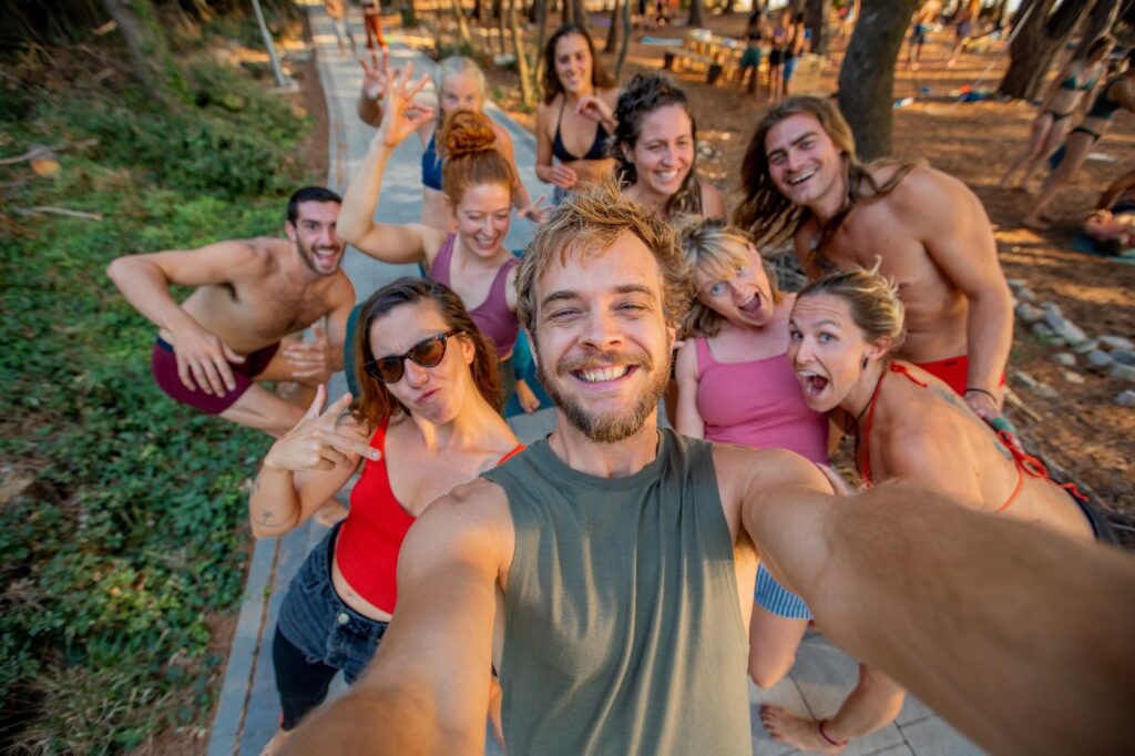 Group selfie of happy people during a barefootyoga retreat in beautiful Croatia. People posing with funny faces, smiling, looking surprised and being happy.