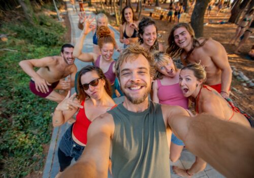 Group selfie of happy people during a barefootyoga retreat in beautiful Croatia. People posing with funny faces, smiling, looking surprised and being happy.