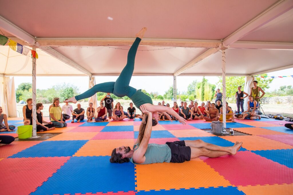 AcroYoga demo on colourful mats during our AcroYoga retreat in Croatia.