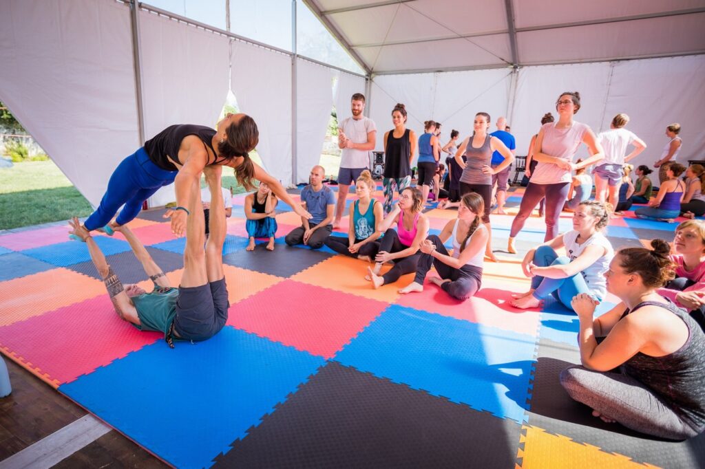 AcroYoga demo in a big tent at our Retreat.