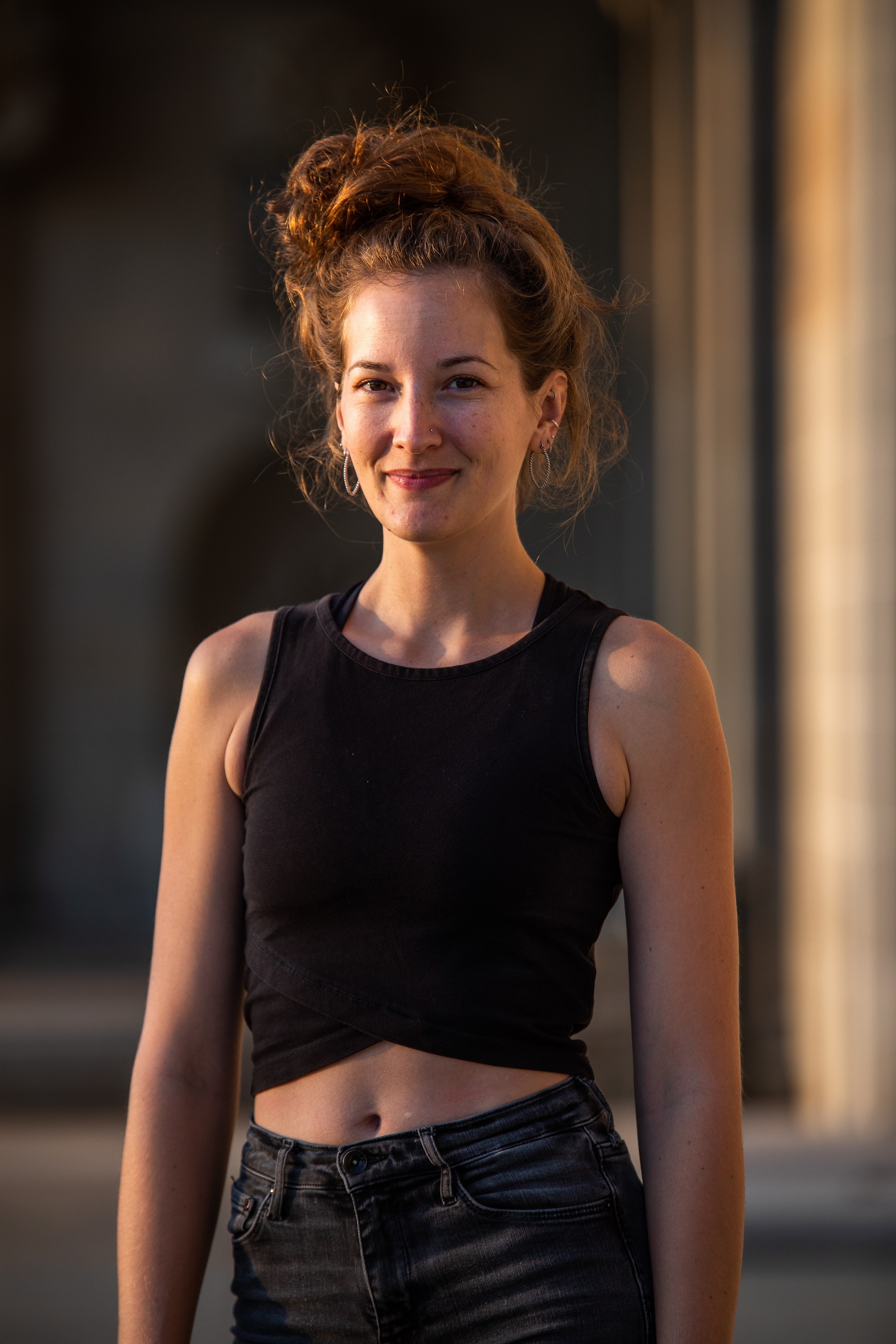 Girl standing in beautiful light in the city.