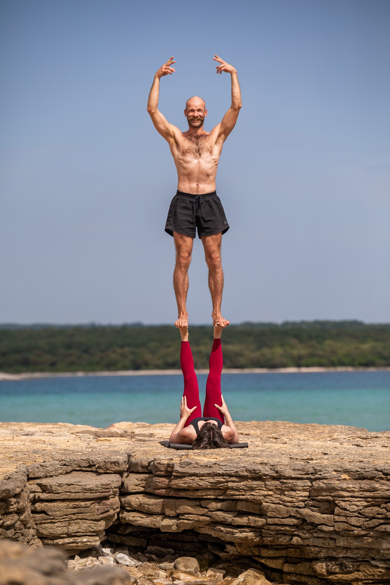 Guy standing high on someone else's feet pretending to be a balarina on the Croatian coast